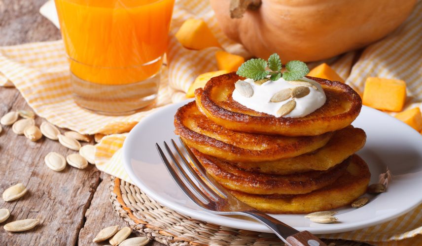 Pumpkin,Pancakes,With,Sour,Cream,And,Juice,With,Pulp,Closeup Pumpkin pancakes with sour cream and juice with pulp closeup horizontal